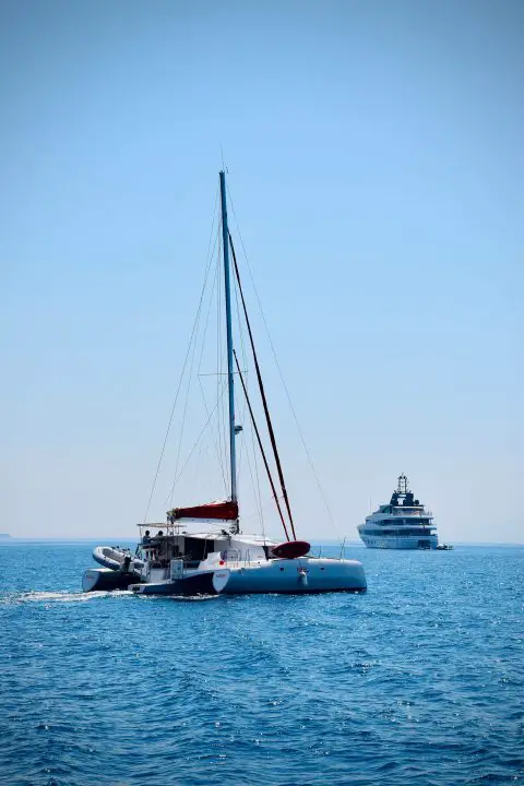 Maritime traffic close to the croatian port city of Split: a rare trimaran in front of a motor yacht