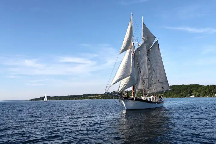 white sail boat on sea during daytime