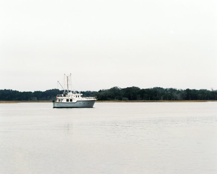 Early morning, fishing boat returning home from sea near the mouth of the St. John’s River in North Florida.